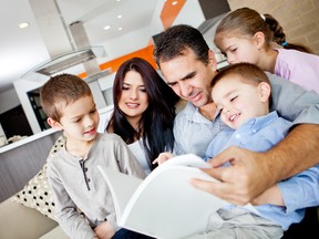 Family reading at home. (Fotolia.com)