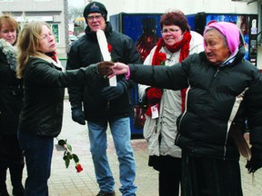 Elder Nancy Morrison (right) hands a feather to Coun. Sharon Smith at the Dec. 6 vigil for women killed in the 1989 Montreal Massacre as well as those murdered in and around Kenora as a result of men’s violence against women. The Kenora Women’s Action Network called on local men to “take up the gauntlet” and become part of the solution to men’s violence.
JON THOMPSON/Daily Miner and News