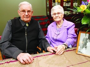 Ralph and June Swanson hold hands as they celebrate their 70th wedding anniversary early in Wetaskiwin. The event included the original announcement in the Times.