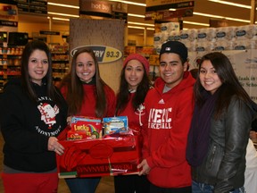 Students from Father Patrick Mercredi High School lend a hand with the Santa's Anonymous Miracle Marathon, Friday at the downtown Safeway location. AMANDARICHARDSON/TodayStaff