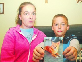 Sylvia Wiebe and her son Kyle hold a picture of Bandit, their Chihuahua puppy killed by another dog in their neighbourhood. (Nick Lypaczewski, Times-Journal)