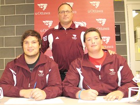 St. Joseph’s Catholic Secondary students and Cornwall Wildcats players Will Green (left) and Matt Smith  (right) have signed letters of intent to play varsity football for the University of Ottawa Gee-Gees. They’re pictured with Luigi Costanzo, a Gee-Gees assistant coach.