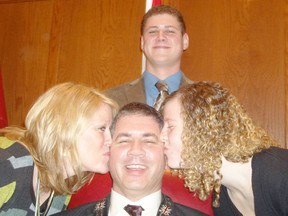 North Stormont Deputy-mayor Bill McGimpsey, centre, receives a double kiss from his wife, Darlene, left, and daughter Alyssa, while son Paul looks on after McGimpsey was sworn in as warden of the United Counties of Stormont, Dundas and Glengarry inside the council chambers on Friday.
Staff photo/GREG PEERENBOOM