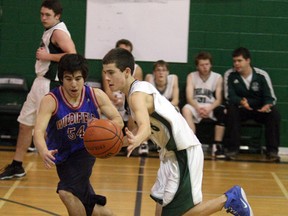 Jackson Brear of the West Ferris Trojans races to the basket while being guarded by Kyle Regimbald in NDA junior boys basketball, Thursday (Ken Pagan, The Nugget)