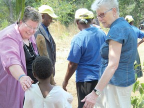 CONTRIBUTED PHOTO
Carol Hamilton and Linda Willis greet Rute, one of the primary students who is being supported in school by Change Her World.