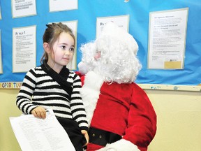 Four-year-old Emery Verch chats with Chris Cringle himself at the Pembroke Ontario Early Years Centre’s Christmas party.