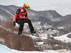 Canada's Dominique Maltais competes during the women's Snowboard-Cross FIS World Cup competition in Stoneham, Quebec, February 21, 2012. Maltais finished seventh. (REUTERS/Mathieu Belanger)