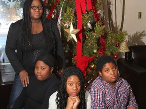 Laura Sharpe is pictured in her Calgary, Alta home Dec 8, 2012 with her children (L-R) Tia Marie, Tenniece, and Terrell. (Jim Wells/QMI Agency)