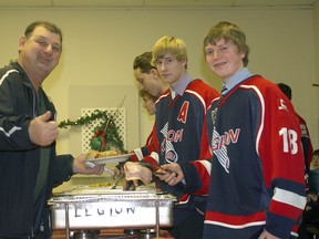 Mike Lazoryshak receives some great food from Legion 87 Marshall Nikitin as his teammate William Wuerch looks on.