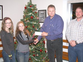 The Cochrane Roping Club donated $10,700 the the Big Hill West 4-H Club. From left are 4-H vice-president Brooke Whitmarsh, 4-H president Emily McBride, roping club president Stan Cena and roping club treasurer Travis Eklund.