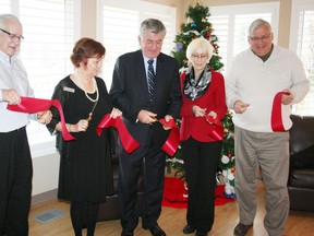 Tillsonburg Mayor John Lessif, Domestic Abuse Services Oxford (DASO) executive director Rhonda Hedel, Oxford MP Dave MacKenzie, DASO board and directors president Marlene Van Ham and Woodstock Mayor Pat Sobeski cut a ribbon to reopen DASO's newly renovated shelter at 975 James St. in Woodstock on Friday, Dec. 8. The facility has received $600,000 in upgrades funded mainly by the federal and provincial governments. JOHN TAPLEY/INGERSOLL TIMES/QMI AGENCY