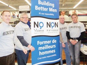 Building Better Men spread their message of healthy relationships on Saturday. Protius Grant, Ray Houde, Wayne McDermid and Dan O’Rourke show off the wristbands they handed out.
Staff photo/KATHRYN BURNHAM