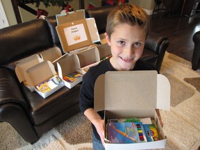 Matthew Gouveia, 9, with some of the school supplies he collected with the help of his classmates at St. Anne Catholic School. They will be shipped to poor, rural and remote areas of Philippines. Gouveia was inspired to help out by the stories he heard from his Kung Fu instructor Jorge de Guzman after he returned recently from visiting the Philippines. Sarnia, Ont., Dec. 4, 2012  PAUL MORDEN/THE OBSERVER/QMI AGENCY