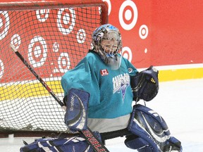 Will Petrie of the West Ferris No Frills bantams makes a save during the 15th Challenge Cup for house teams novice through midget at Pete Palangio, Sunday. The boards were a festive red courtesy of Target stores, a sponsor of the 28-team tournament.