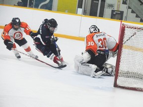 Kurtis Pettitt of the Norfolk Rebels heads towards Ben Beechey, goaltender with the Burford Bulldogs, during his team’s 6-5 overtime loss Sunday afternoon to the Bulldogs at home. (DANIEL R. PEARCE Simcoe Reformer)