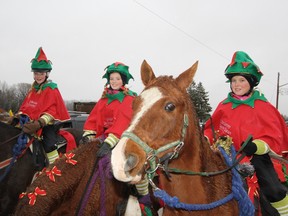 Young  riders from Whinny Acres Farm near Priceville in the Holstein Santa Claus parade, from left, are Emily Pust, Cassidy Cook and Kassidy Holloway.