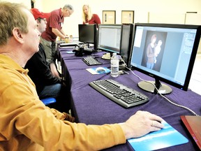 Volunteers with Help Portrait, run portraits through an efficient gauntlet of retouching and printing for the clients who took advantage of the day long free photo session in Chatham Saturday. (DIANA MARTIN Chatham Daily News)