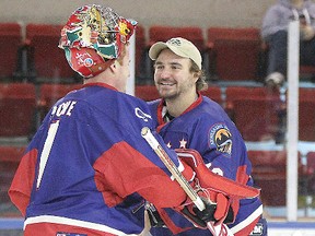 Loic Lacasse, at right, is all smiles as he gives the game puck to Fred Piche, following the Cornwall River Kings’ 8-6 victory against Riviere-du-Loup Saturday night in Cornwall. It was the first career LNAH victory for Piche, who entered the game in relief of Lacasse.