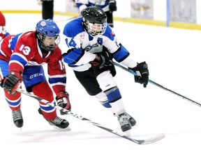 North York Knights' Jake Muchnik, right, tries to skate around Hillcrest Canadiens' Adam Rethy during the minor midget 'AA' championship game at the annual Chatham Regional Silver Stick Tournament on Sunday at Thames Campus Arena. Hillcrest won 4-1. The host Kent Cobras did not reach any of the seven division finals, although the Minor Atom 'AA' and Minor Peewee 'AA' Cobras were semifinalists. (MARK MALONE/The Daily News)