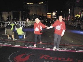 Churchill crosses the finish line with daughter Sue Krawchuk, who paid Churchill’s way to the race as an 80th birthday present.