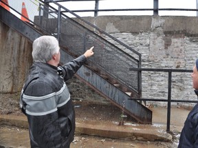 Joel Carr-Braint, (left) a city property manager, points out a deteriorating wall at a Belleville parking lot, to engineer, Dennis Baxter, who will draft a report outlining necessary repairs. JASON MILLER/THE INTELLIGENCER/QMI AGENCY