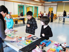 From left, Alexia Trigg, Kodan Whitehorse and Charlie Petrovich of Miss. Grande’s Grade 3 class got a chance to shop for Christmas presents during the Holiday Gift Shop program at Central School on Dec. 6.
Barry Kerton | Whitecourt Star