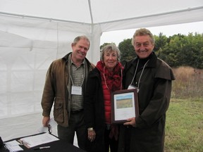 Helen and Andy Spriet donated $150,00 to the Nature Conservancy of Canada in order to protect the natural beauty of the land they love. Here they are presented a plaque in appreciation of their contribution by John Nicholson (left) of the Ontario Board of Directors for NCC. (CONTRIBUTED PHOTO)