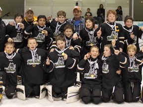 The Portage Peewee #3 Terriers team celebrates with their gold medals at the Brandon Coaches Tournament this past weekend. The team were champs of the A Side after going a perfect 4-0 on the weekend, including a 2-1 defeat of Virden in Sunday's final. (Handout)