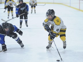 Waterford captain Aiden Scott carries the puck deep in Caledonia territory and looks for an open teammate Monday at the Waterford Tricenturena. Caledonia won the game 5-3. (JEFF DERTINGER Simcoe Reformer)