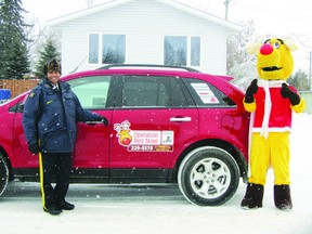 Const. Shannon Neff pictured with mascot Rudy in front of an Operation Red Nose vehicle at the RCMP detachment in Portage la Prairie. The free service drives people who have been drinking home.