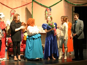 Director Stephanie McLachlan (in the blue dress) receiving flowers from her cast members after a presentation of "Dashing Through the Snow" at the Fred Speckeen theatre on Friday, Dec. 7, 2012. The show was presented by the College Town Capers community theatre group. (Simon Arseneau/Fairview Post)