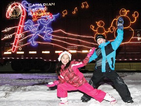 Two children pose for a picture in front of the CP Holiday Train as it rolls into Wetaskiwin Dec. 10, 2012. SARAH O. SWENSON/WETASKIWIN TIMES/QMI AGENCY