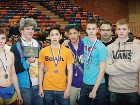 Members of the Wetaskiwin Composite High School Sabres wrestling team pose with the spoils of victory after several grapplers won medals at the Calgary tournament. As a team, the Sabres finished first overall. The team continues its wrestling season as it heads to Lethbridge for a tournament this Saturday.