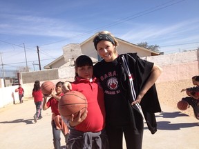 Starman poses with one of the Mexican children she coached and played basketball with.