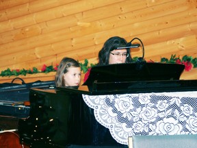 Miriam Epp, left, and Lianna Epp play the first numbers of the night, Go Tell it on the Mountain and Good King Wenceslas, during the Evening With Music: Celebrating the Season concert at the Whitecourt United Church on Saturday, Dec.