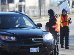 Steven Brown, left, and Brian Blake with Teamsters Local 879 picket nearby the Point Edward Casino, near Sarnia Ont. on Tuesday Dec. 11, 2012. The 38 unionized security guards at the casino have been locked out since Saturday. (TYLER KULA/ THE OBSERVER/ QMI AGENCY)