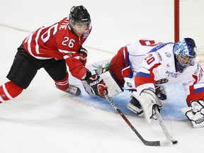 Team Canada's forward Ty Rattie races for the puck against Team Russia's goalie Andrei Makarov during the first period of the Canada-Russia Challenge at the Metro Centre in Halifax, Nova Scotia, August 13, 2012. (REUTERS/Paul Darrow)