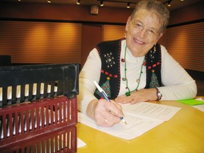 Barb Kaufman, coordinator of the Norfolk Christmas Exchange prepares paperwork at the program’s office in the Simcoe Town Centre Mall. Dec. 12 is the final day to register for a basket. (SARAH DOKTOR Simcoe Reformer)