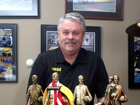 Al Kenny, the 2012 champion in the National Hot Rod Association Super Comp division, with some of the NHRA trophies he's won over the years. He’s now home in Kingston. (Ian MacAlpine/The Whig-Standard)
