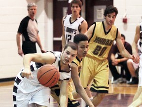 Knights’ Ray Duplin goes after the ball while being defended by Korah’s Sam Ivey as Liam Train (20) looks on.