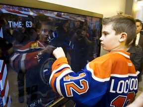 Ethan Lockwood, 11, plays a demolition derby game at the newly opened Oilers Interactive Learning Centre at the Glenrose Rehabilitation Hospital in Edmonton, Alta., on Wednesday, December 5, 2012. Ian Kucerak/QMI Agency