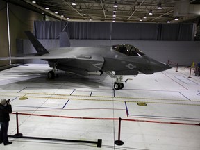 A photographer takes pictures of the F-35 Lightning II Joint Strike Fighter at the Naval Air Station (NAS) Patuxent River, Maryland in this January 20, 2012 file photo. (REUTERS/Yuri Gripas)