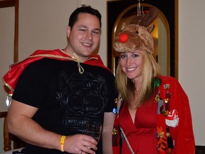 Guests of the second annual Ugly Sweater Christmas Party Wade Trefrey and Tracy Doll posed for a picture in their special attire.