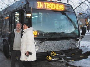 Canmore Mayor John Borrowman and Banff Mayor Karen Sorensen pose for photos outside one of the 40-foot biodiesel buses that run between Canmore and Banff during a press conference announcing the start of service on Friday morning, Nov. 30, 2012. Russ Ullyot/ Canmore Leader/ QMI Agency
