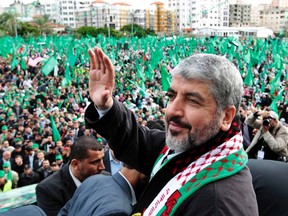 Hamas chief Khaled Meshaal waves to the crowd in Gaza City on Dec. 8 during a rally marking the 25th anniversary of the founding of Hamas. Meshaal, in an uncompromising speech during his first visit to Gaza after decades of exile, told a mass rally that he would never recognize Israel and pledged to 'free the land of Palestine inch by inch.'