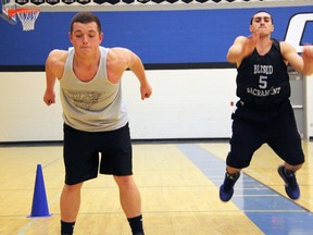 St. Chris Cyclones guards Josh Elsley, left, and Mike Rocca do frog jumps during practice at St. Christopher's Catholic Secondary in Sarnia. (PAUL OWEN, The Observer)