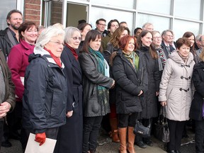Members of community groups that received grants from the Community Foundation of Kingston and Area on Wednesday morning gather outside the Pathways to Education office on Weller Avenue. (Ian MacAlpine The Whig-Standard)