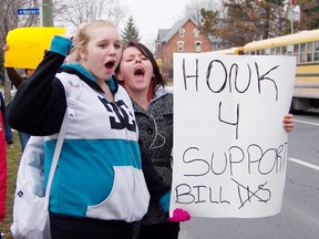 Ceara Veldhoven and Emily Vallieres were outside Cornwall Collegiate and Vocational School on Wednesday, protesting Bill 115, and demanding the return of extracurricular activities.
Staff photo/ERIKA GLASBERG