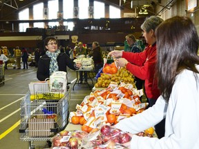 Volunteers fill their carts with all the fixings for a turkey dinner to give to families as part of the Children's Christmas Fund.
File photo