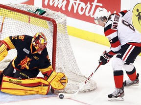 Belleville Bulls goalie Charlie Graham stops Ottawa 67's attacker Ryan Van Stralen at the side of the net during OHL action Wednesday night at Scotiabank Place in Ottawa. (Tony Caldwell/QMI Ottawa Sun)